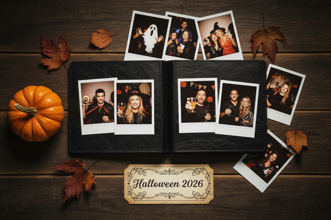 Polaroid photo album open on a table with Halloween instant prints, a small pumpkin, and dried autumn leaves arranged around it