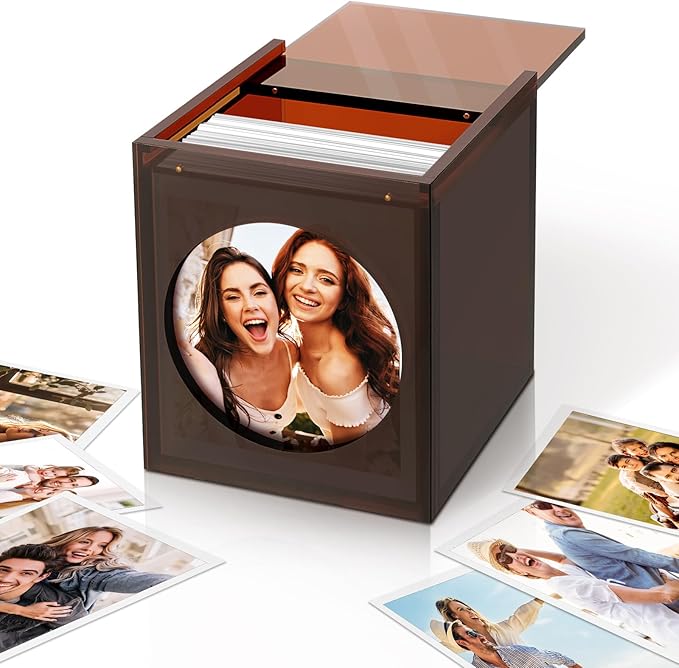 Archival photo storage box with clear lid, custom photo window, and scattered prints